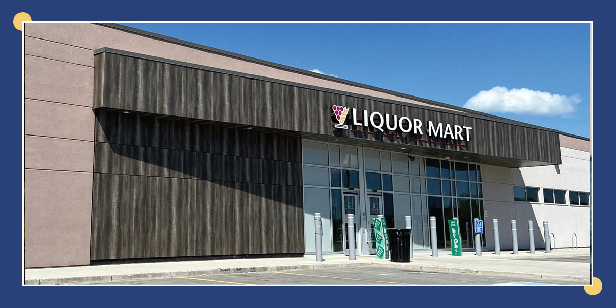 Photo of the external Thompson Liquor Mart building. Inside the photo, a dark blue box in the centre of the photo is the text “Thompson Liquor Mart achieves LEED Canada Gold Certification”. 
