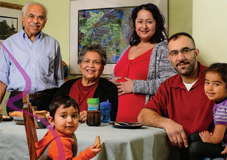 Happy family sitting around the dining room table.