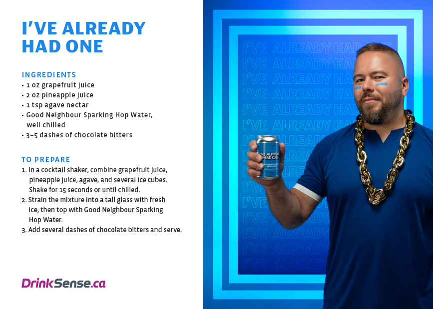 Man wearing a blue shirt with a large gold chain holding a blue canned drink